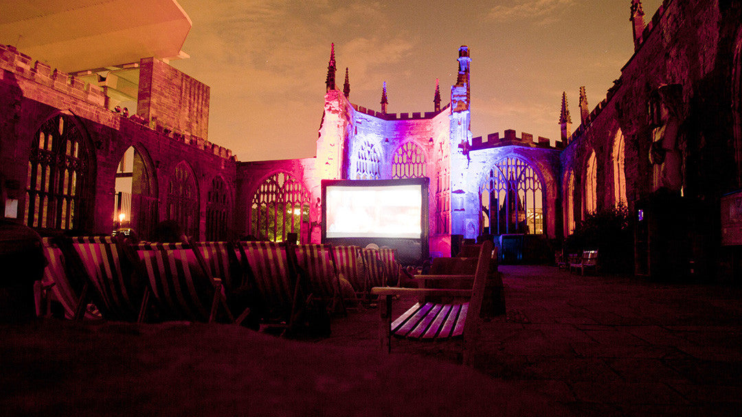 Outdoor cinema experience with a cocktail.